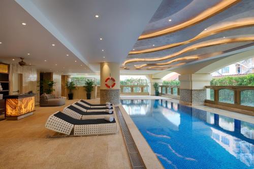 a swimming pool in a building with a swimming pool at Sherwood Suites in Ho Chi Minh City
