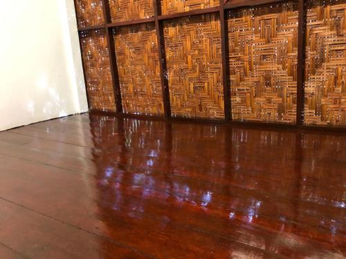 a room with a wooden floor and a wall at Andaman Sunflower in Ko Lanta