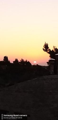 a sunset with the sun in the background at Ble Mavi - Studio for 2 in Vouni