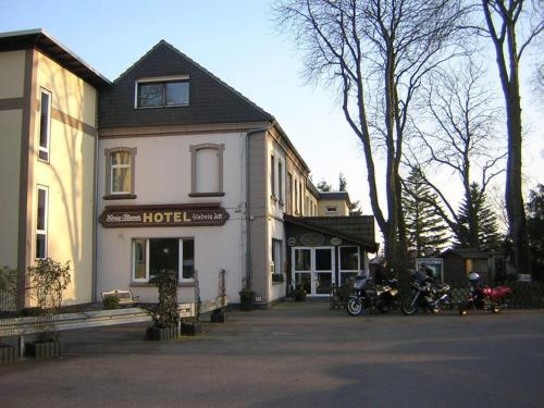 a hotel with motorcycles parked in front of it at Hotel Zum Grunewald in Dinslaken