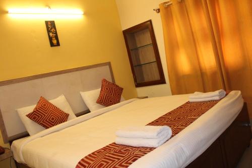 Katil atau katil-katil dalam bilik di Hotel Kaveri
