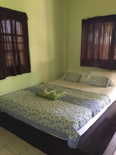a bedroom with two beds and two windows at Janina resort Koh chang in Ko Chang