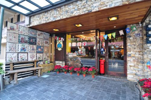 a store with a bench and flowers in front of it at Yong Guan in Yuchi