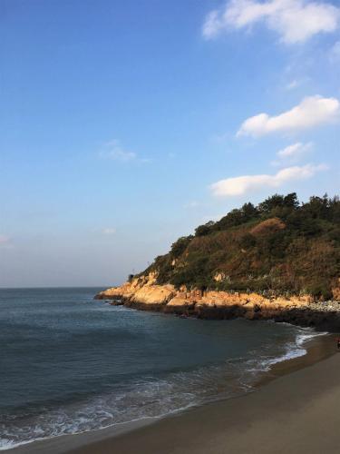 an island in the ocean next to a beach at Jin Sha Ting Hai Homestay I in Nangan