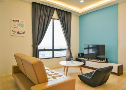 a living room with a couch and a table at USJ One HomeStay @ Subang HomeStay in Subang Jaya