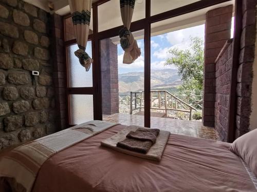 a bed in a room with a large window at Lalibela Apartments in Lalibela