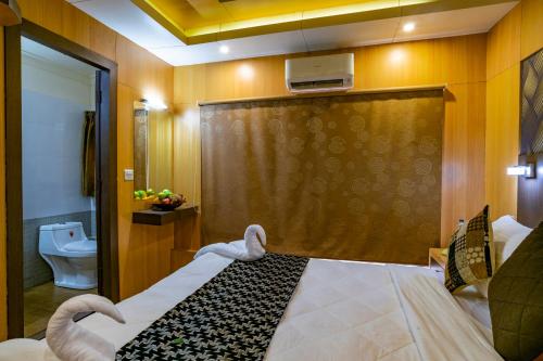 a bedroom with a bed and a toilet at Southern Panorama Houseboats in Alleppey