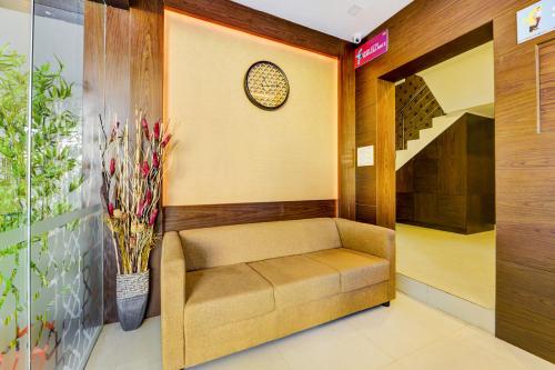 a waiting room with a bench and a staircase at FabHotel Sky Bay in Chennai