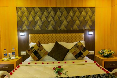 a bedroom with a large bed with red roses on it at Southern Panorama Houseboats in Alleppey