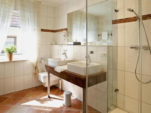 a bathroom with two sinks and a shower at Hotel Engel in Rheinmunster