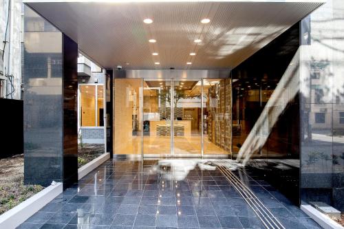a hallway of a building with glass walls at Hotel Lantana Naha Matsuyama in Naha