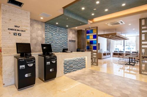 a lobby with a check in counter in a building at Hotel Lantana Naha Matsuyama in Naha