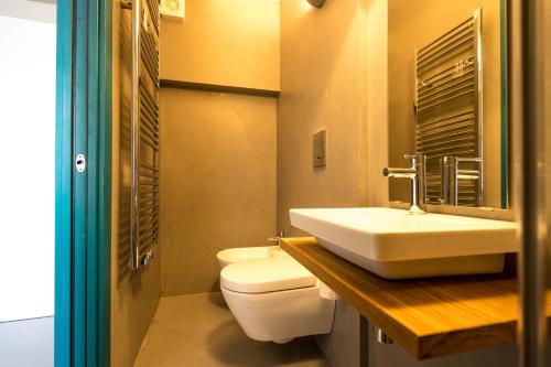 a bathroom with a white toilet and a sink at CABANON urban apartments in Peschiera del Garda