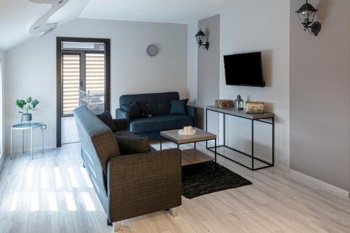a living room with a couch and a tv at The Red Roof House in Plovdiv