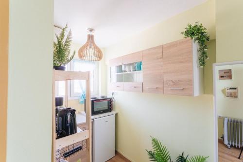 a room with a small kitchen with a small refrigerator at Tropical Loft with View in Volos