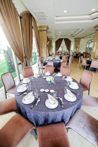 a dining room with a table with plates and silverware at LK Celestite in Pattaya South