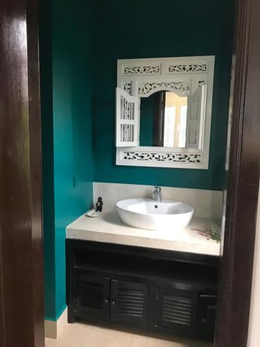 a bathroom with a sink and a mirror at Hotel La Java Bleue in Kampot
