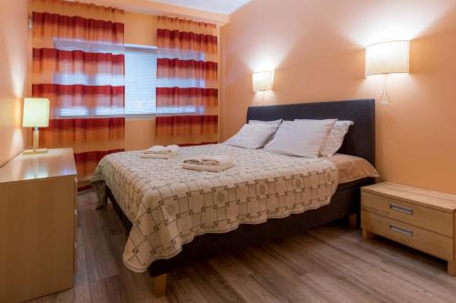 a bedroom with a bed with two towels on it at Viiking Spa Hotel in Pärnu