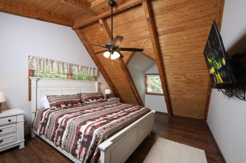 een slaapkamer met een bed en een plafondventilator bij Bear Trails cabin in Gatlinburg