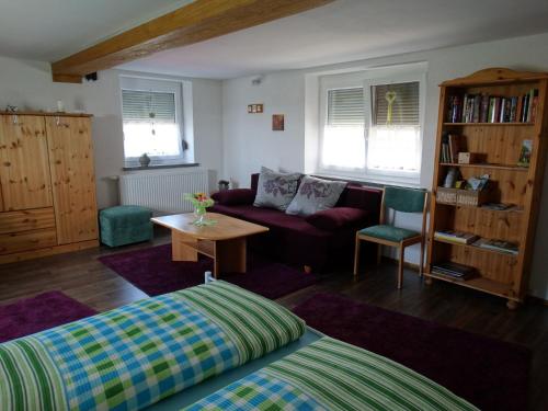 a living room with a couch and a table at Ferienwohnung Landblick in Bucha