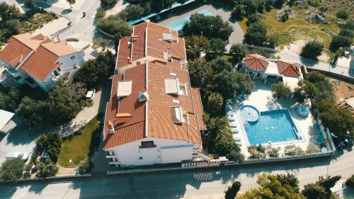 an aerial view of a house with a swimming pool at Resort Trcol in Novalja