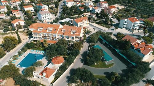 an aerial view of a house with a swimming pool at Resort Trcol in Novalja
