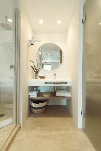 a bathroom with a sink and a mirror at ICON Valparaiso - Adults Only in Cala Murada