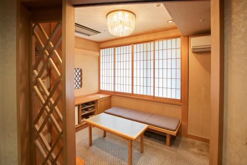 a meditation room with a bench and a window at Myogi Green Hotel in Tomioka