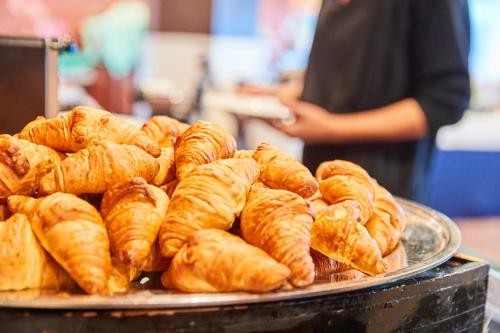 a pile of croissants on a plate on a table at Myogi Green Hotel in Tomioka