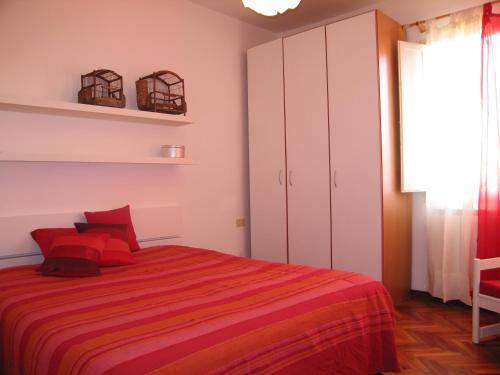 a bedroom with a large bed with red pillows at Your apartment in the Heart of Florence in Florence