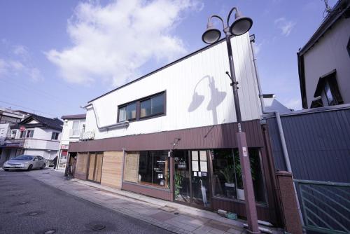 a building with a street light in front of it at Guest House Kadoyasu in Kanazawa