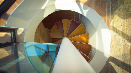 a spiral stairwell with a glass bowl in the middle at Miataland in Collazzone