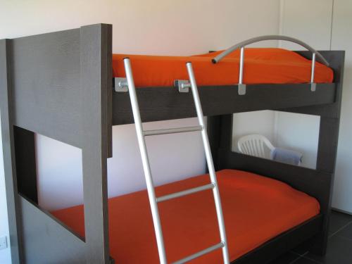 a bunk bed with a ladder in a room at Trident Beach Apartment in Protaras