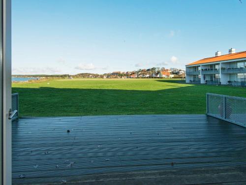 a deck with a view of a baseball field at 4 person holiday home in Ebeltoft in Ebeltoft