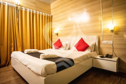 a bedroom with a large bed with red pillows at Zulu Land cottages - near Curlies beach shack and shiva valley - Anjuna beach in Anjuna