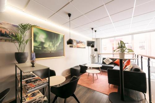 a living room with a couch and a table and chairs at SPiS Hotell Naran in Luleå