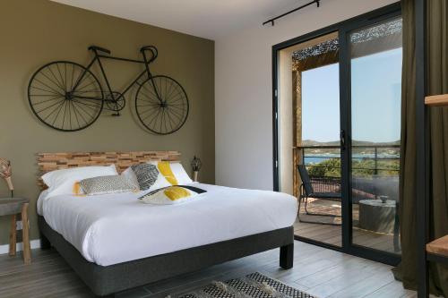a bedroom with a bed and a bicycle at Résidence Casarina in Bonifacio