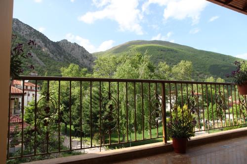 a balcony with a view of a mountain at Xenonas Platia in Kato Loutraki