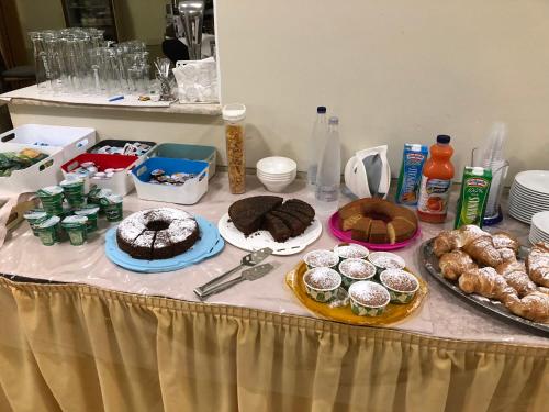 a table topped with cakes and pastries and other desserts at Hotel River in Civitella Roveto