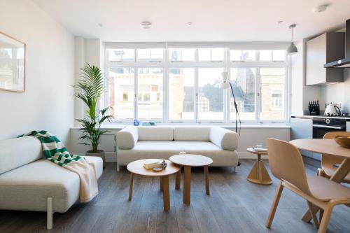 a living room with a couch and a table at Hausd - Leicester Square in London