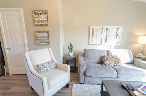 a living room with a couch and a chair at Colony Suites in Palmer