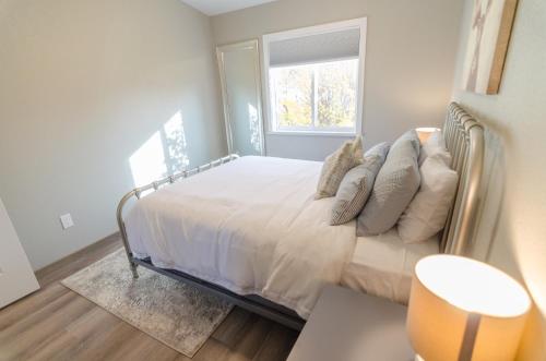 a bedroom with a bed with pillows and a window at Colony Suites in Palmer
