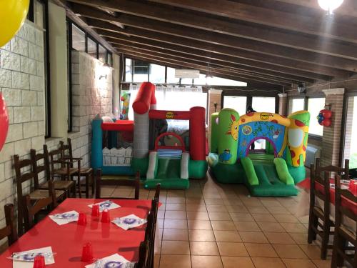 a dining room with a table and a play area at Hotel River in Civitella Roveto