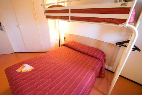 a bedroom with a bunk bed with a ladder at Premiere Classe Le Blanc Mesnil in Le Blanc-Mesnil