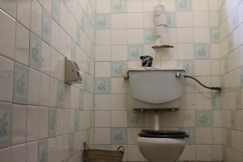 a bathroom with a white toilet in a room at Kiwavi Home in Moshi