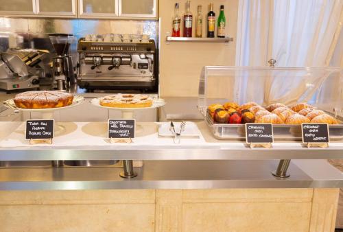 a bakery counter with different types of bread and pastries at Hotel Patavium in Padova