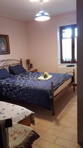 a bedroom with two beds and a window at Katerinas Guest House in Leonidio