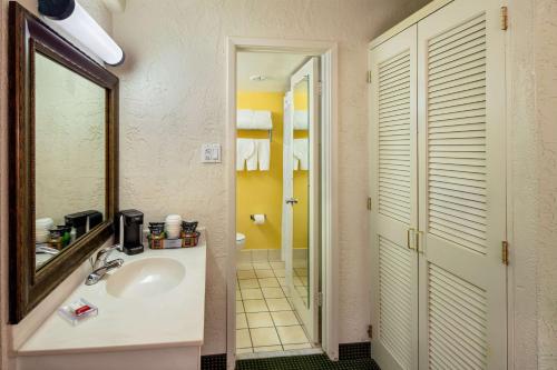 a bathroom with a sink and a mirror at Ramada by Wyndham Tucson in Tucson