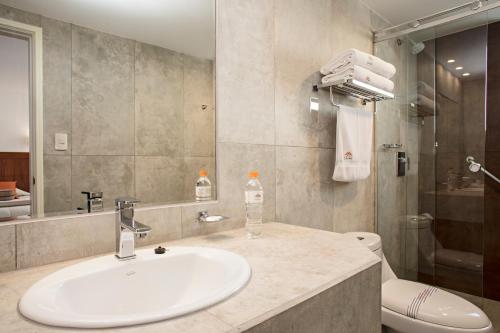 a bathroom with a sink and a toilet at Camino Real Aparthotel, Downtown in La Paz