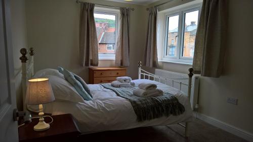 a bedroom with a bed with two stuffed animals on it at Cooks Row in Scarborough